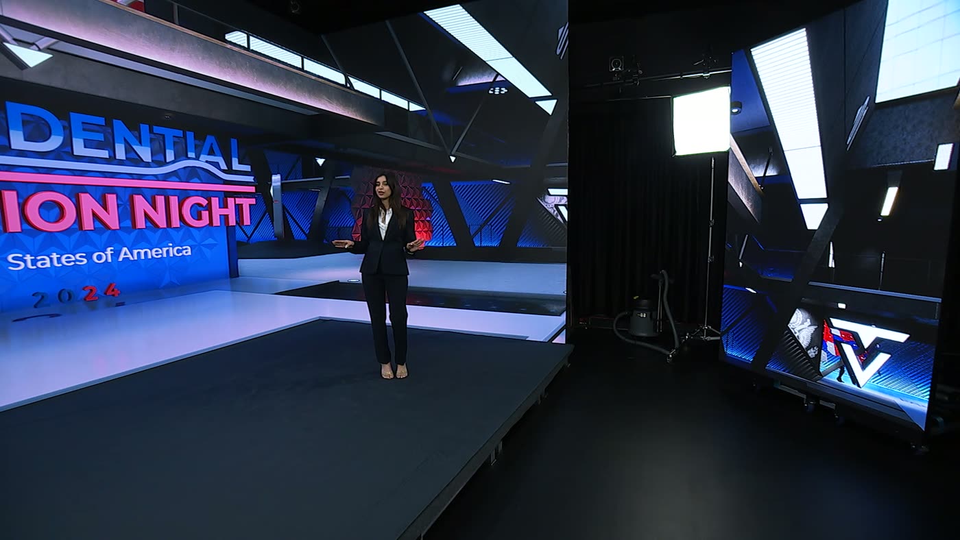Wide studio shot with a results map on the floor